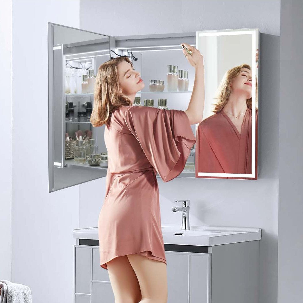 Illuminated mirror cabinet above a vanity